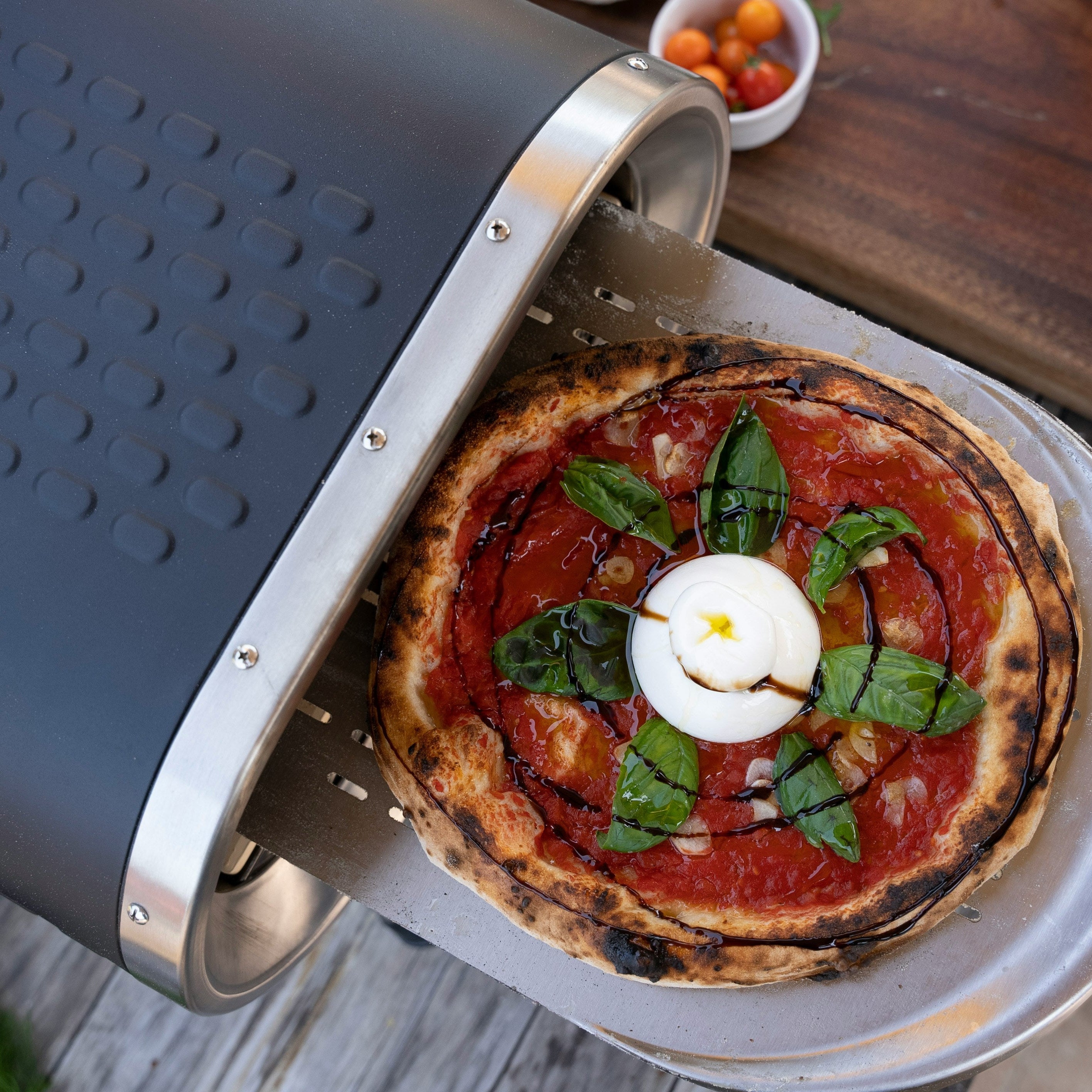 Portable pizza oven on patio table